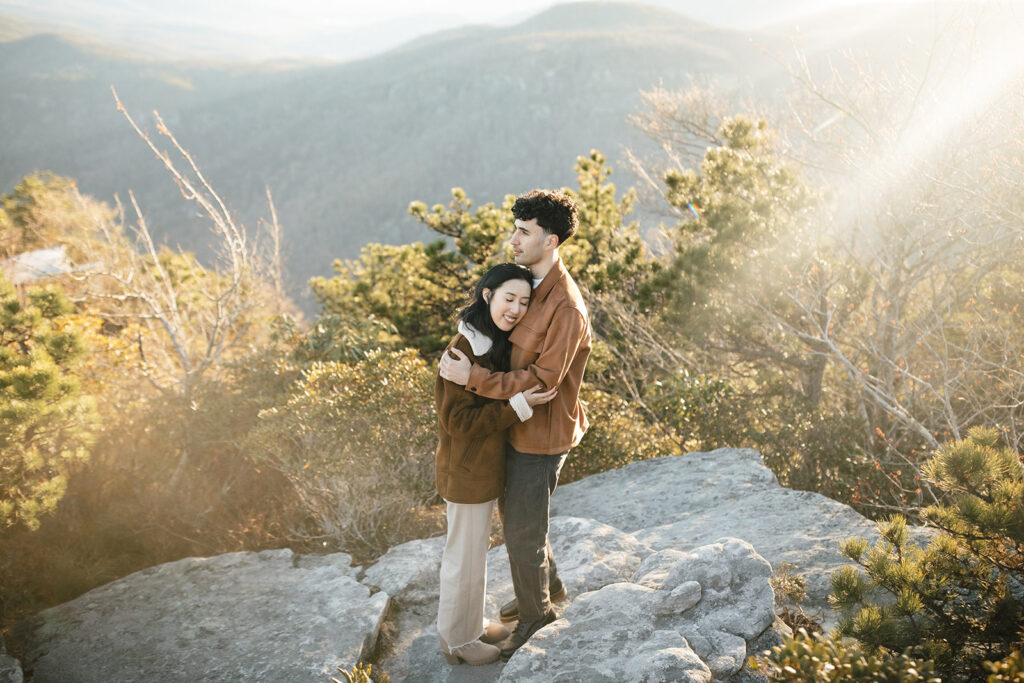 asheville engagement photographer captures couple on a mountaintop in linville gorge