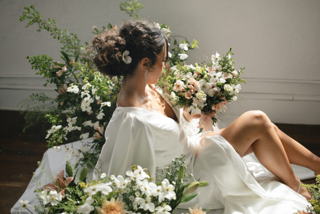 bride posing with flowers photographed by asheville wedding photographer